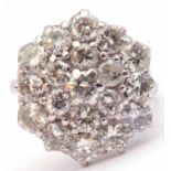 Diamond cluster ring, the circular panel set with three tiers of round brilliant cut diamonds,