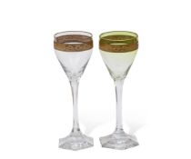 Pair of wine glasses, probably Moser, with green tint and a gilt engraved band above a faceted