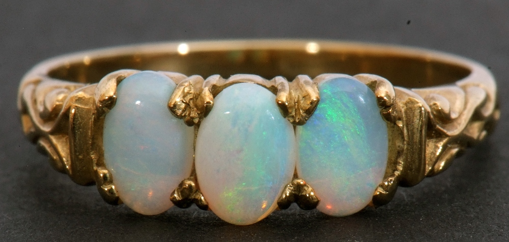 9ct gold and opalescent three-stone ring, featuring three oval cabochon opalescents, individually