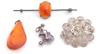 Mixed Lot: white metal penny-farthing charm, a filigree brooch, an amber drop pendant and a