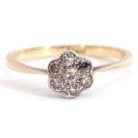 Small diamond cluster ring featuring seven small diamonds in a flowerhead design with millegrain