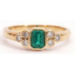 Modern 18ct gold, green stone and diamond ring, rectangular faceted cut green stone flanked by three