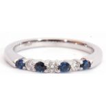 Modern sapphire and diamond ring, alternate set with four round cut sapphires and three round