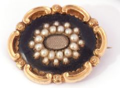 Early Victorian gold, black enamel and seed pearl mourning brooch, the centre with a glazed panel of