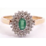 18ct gold emerald and diamond cluster ring, centring an oval faceted cut emerald raised above two