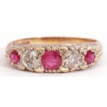 9ct gold ruby and diamond ring, having three round cut graduated rubies and two brilliant cut