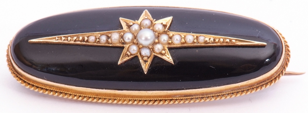 Victorian onyx and pearl brooch of oval form, the slightly curved onyx panel applied with a seed