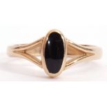 9ct gold and onyx ring, the oval shaped onyx panel in rub-over setting and raised between pierced