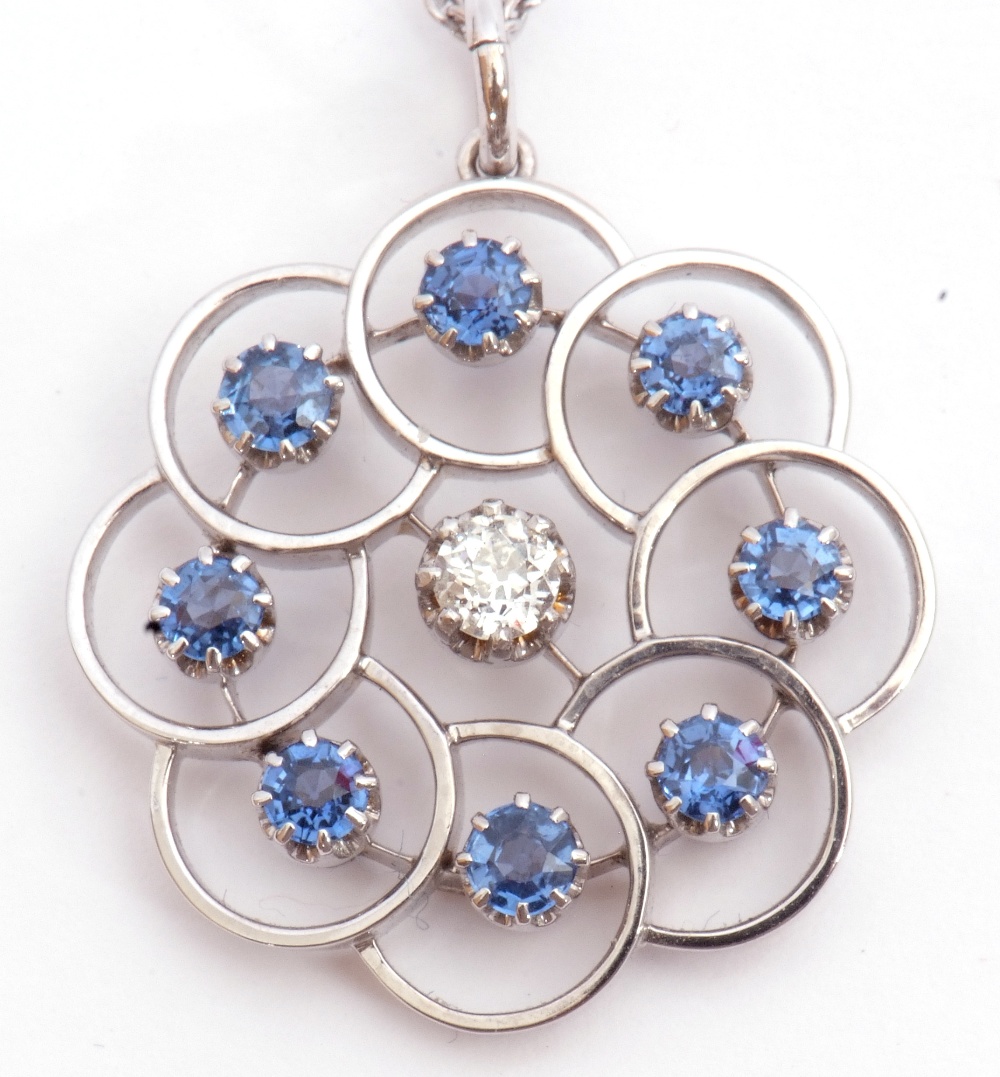 Precious metal, diamond and sapphire open work pendant on chain, centring an old European cut