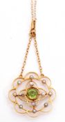 9ct stamped open work pendant and chain, circular scroll shape with central round peridot, bezel set