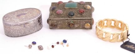 Two metal jewel boxes, an oval table box, a stone and filigree box inside a gilt hinged bracelet and