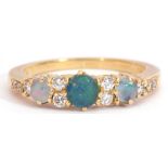 18ct gold, opal and diamond ring, featuring three graduated round cut opals, interspersed by ten