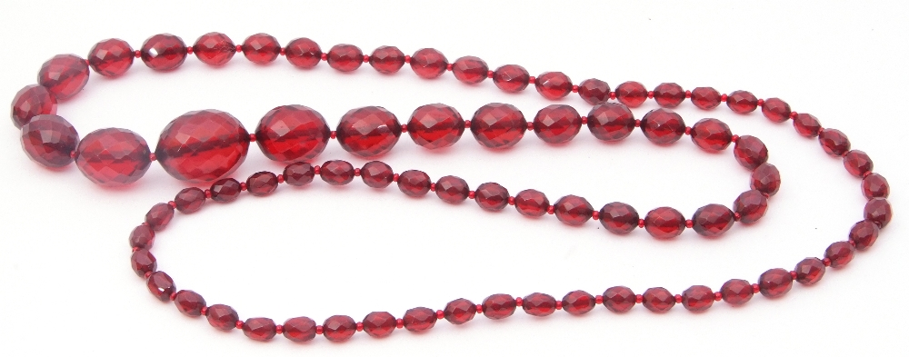 Vintage cherry amber faceted bead necklace, a single row of graduated oval beads, .5cm to 2.5cm
