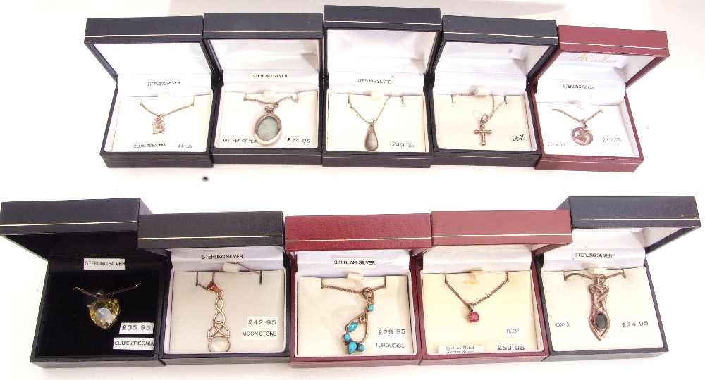 Mixed Lot: ten white metal pendants/necklaces to include turquoise, ruby, and cubic zirconia