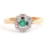 Modern 18ct gold emerald and diamond cluster ring, the round cut emerald four claw set and raised