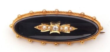 15ct stamped onyx, diamond and seed pearl mourning brooch, the elongated oval onyx panel applied