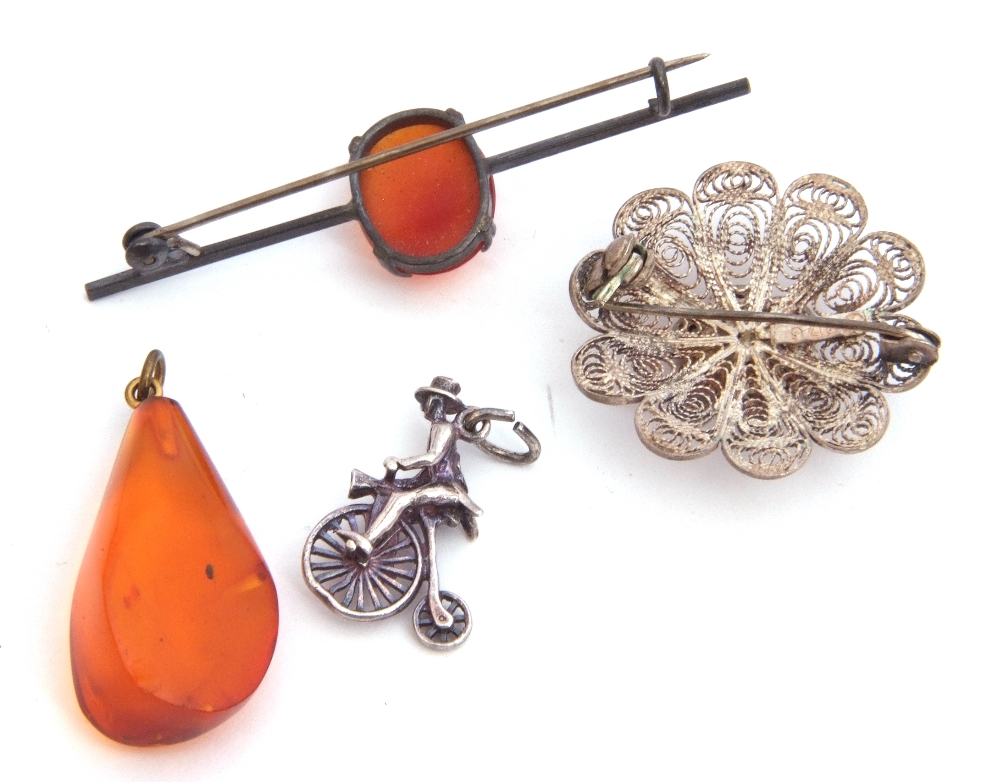 Mixed Lot: white metal penny-farthing charm, a filigree brooch, an amber drop pendant and a - Image 2 of 2