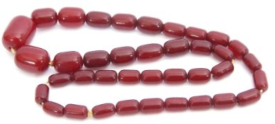 Vintage cherry red amber bead necklace, a single row of graduated oblong beads, 1cm - 2.5cm diam,