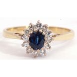 18ct gold sapphire and diamond cluster ring, the oval faceted sapphire multi-claw set above a