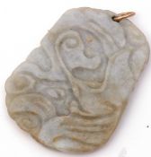 Antique carved jade pendant of shaped rectangular flat form, deep carved with a naturalistic detail,