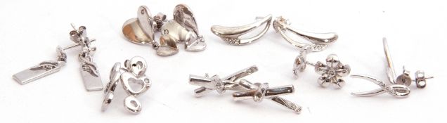 Mixed Lot: seven pairs of white metal earrings highlighted with small single cut diamond(s), each