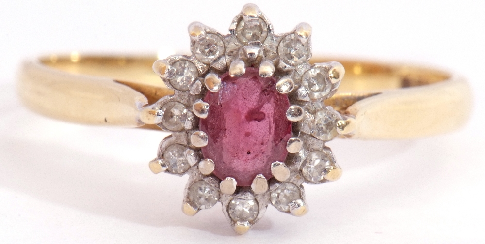 Ruby and diamond cluster ring, featuring an oval faceted small ruby, multi-claw set and raised