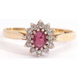 Ruby and diamond cluster ring, featuring an oval faceted small ruby, multi-claw set and raised