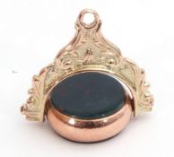 Victorian 9ct gold swivel fob with bloodstone and carnelian sides, framed in a scroll mount