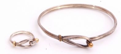 Matching stylised bracelet and ring, a looped design with reeded rims with yellow metal sphere and