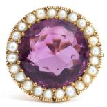 Large amethyst and seed pearl dress ring, the round cut amethyst, 14mm diam, set within a surround