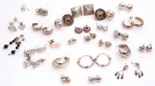 Twenty pairs of mainly white metal earrings together with six single earrings, g/w 38.8gms