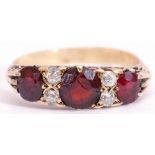 Antique garnet and diamond ring, having three graduated oval faceted garnets (centre stone cracked),