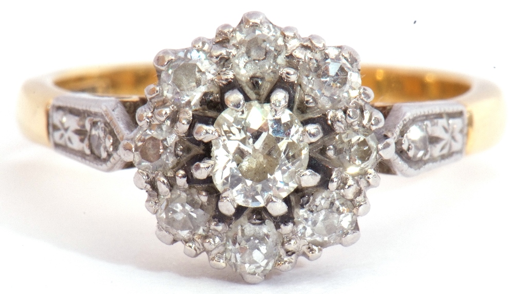 Diamond cluster ring centring an oval cut diamond of 0.20ct approx, raised within a diamond set