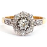 Diamond cluster ring centring an oval cut diamond of 0.20ct approx, raised within a diamond set