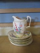CROWN STAFFORDSHIRE JUG AND QUANTITY OF SAUCERS