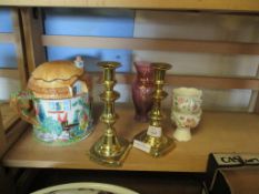 PAIR OF BRASS CANDLESTICKS AND A LARGE CERAMIC TEA POT AND COVER MODELLED AS A COUNTRY COTTAGE