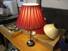 TABLE LAMP WITH RED SHADE AND TRAY CONTAINING LAMP SHADES