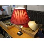 TABLE LAMP WITH RED SHADE AND TRAY CONTAINING LAMP SHADES