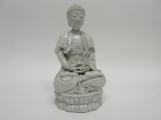 Chinese Ming dynasty style blanc de chine Dehua white glazed figure of Rulai in typical pose, 20cm