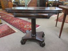 Early 19th century rosewood fold-top tea table, cylindrical column and quadruped base, 92.5cm wide