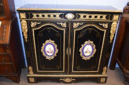 19th century ebonised and gilt metal mounted side cabinet, the frieze and two doors applied in the
