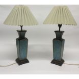 Pair of Chinese pottery green glazed table lamps of faceted form with scroll decoration (2)