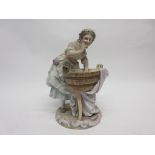 Late 19th century Continental porcelain model of a washer girl on a circular base with tub of