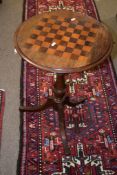 Mahogany pedestal games table with chequerboard inset, balustered support and tripod base, 46cm