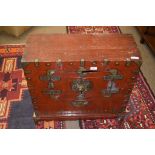 Oriental red stained and brass mounted chest, two small doors to front enclosing a void interior