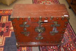 Oriental red stained and brass mounted chest, two small doors to front enclosing a void interior