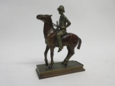 Vintage spelter figure of a mounted female polo player, 19cm high