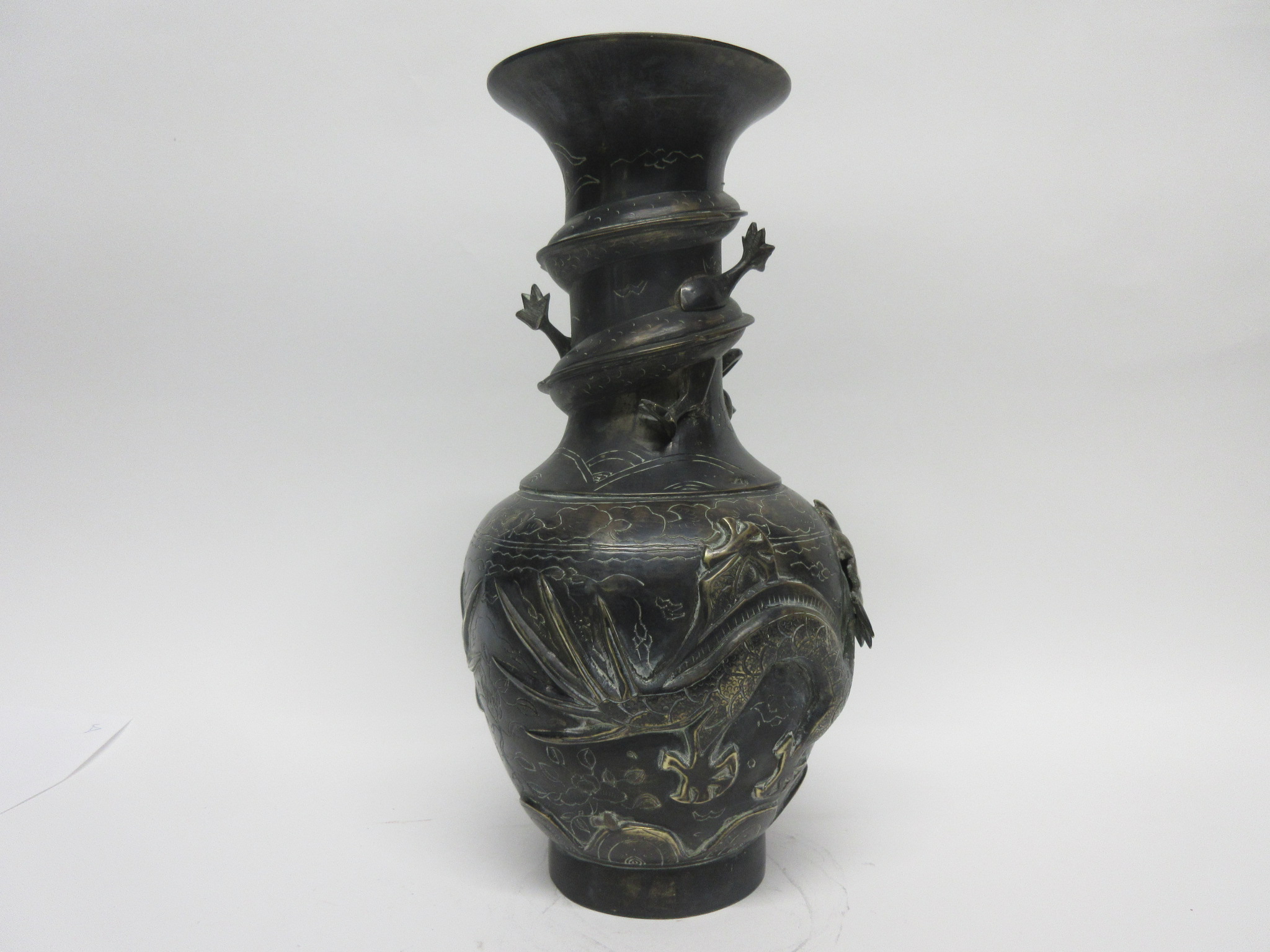 Metal vase, the neck with sinuous dragon and body also modelled in relief with two dragons and the