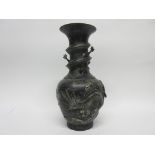 Metal vase, the neck with sinuous dragon and body also modelled in relief with two dragons and the