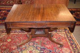 An early 19th century mahogany sofa table fitted on one side with two frieze drawers flanked on